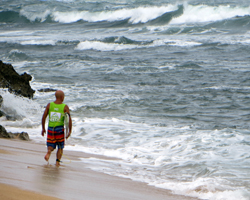 Michael Ho prepares to paddle out at the 2013 Reef Hawaiian Pro, Vans Triple Crown of Surfing