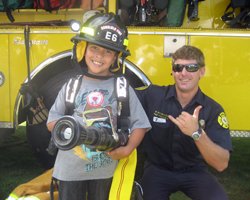 My Son Showing the Firefighter How Things Work at Bishop Museum Healthy Kids Day